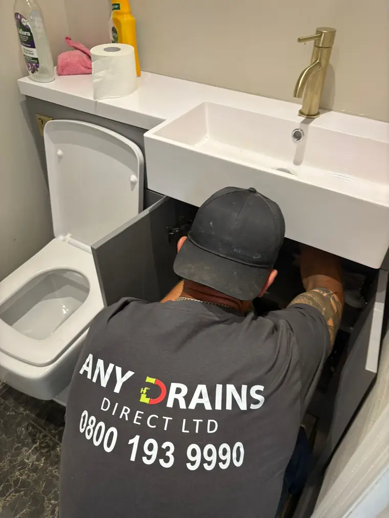 Any Drains engineer clearing a blocked sink and toilet